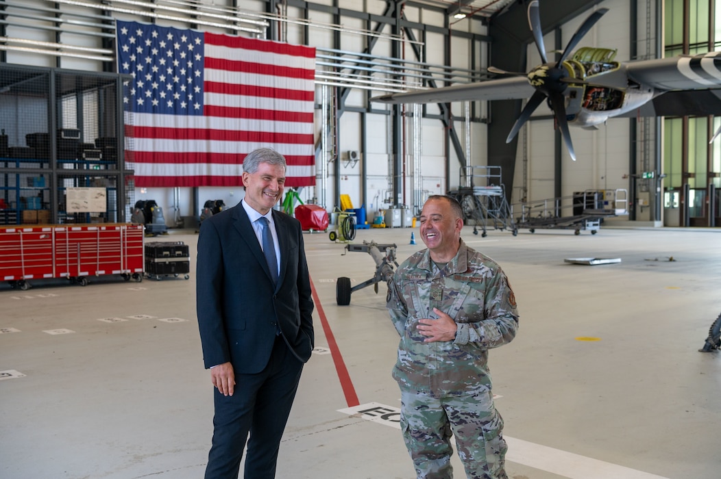 Metin Hakverdi, German Coordinator of Transatlantic Cooperation, left, receives a mission brief from U.S. Air Force Master Sgt. Devon Bullock, 37th Aircraft Maintenance flight chief