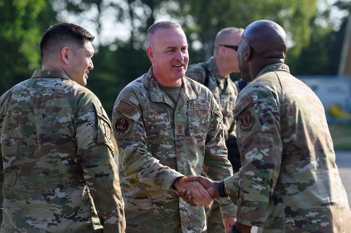 Two U.S. Air Force Airmen shake hands.