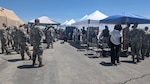 Photo of crowd of Airmen, officers, and others gathered outside to observe drone technologies.
