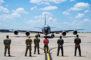 Members of the 350th Air Refueling Squadron stand behind a crew chief to honor A KC-135 Stratotanker’s final flight out of McConnell Air Force Base, Kansas, July 14, 2026. The jet was flown to MacDill Air Force Base, Florida, by a crew from the 99th Air Refueling Squadron out of Birmingham Alabama. (U.S. Air Force photo by Airman 1st Class Patrick O’Neill)