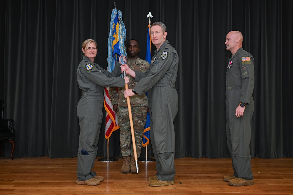 A man holds a guidon.