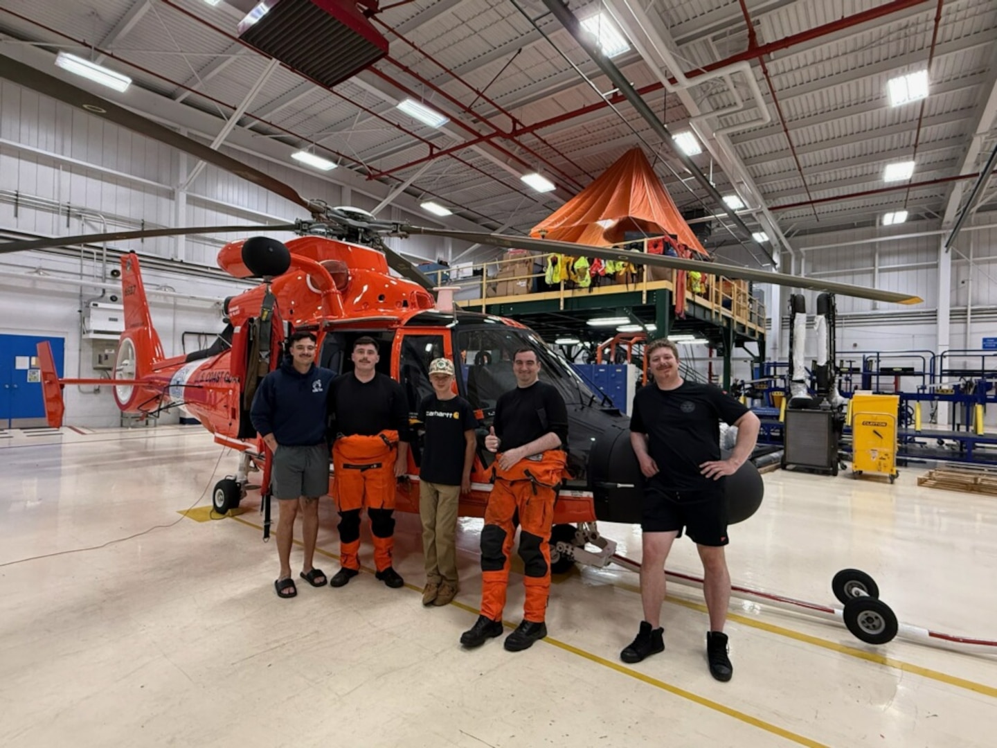 A Coast Guard helicopter aircrew poses with a teen that was successfully rescued from a cliff at Sue-Meg State Park, July 20, 2026. The Air Station Humboldt Bay MH-65 Dolphin helicopter crew hoisted the 13-year-old boy from a ledge approximately 200 feet above Agate Beach and safely transported him to the air station with no reported injuries. (U.S. Coast Guard courtesy photo)