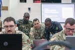 U.S. Army Chief Warrant Officer 2 Kyle Barboza, 176th Cyber Protection Team, assists international service members from Zambia, teaching cyber detection and incident response at the Professional Education Center in Little Rock, Arkansas, on July 15, 2026. Cyber Shield 2026 is the largest annual Department of Defense cyber training event, consisting of more than 1,000 participants from 44 states and territories as well as 23 countries who have gathered to collaborate and strengthen cyber capabilities on a global scale. Photo by Sgt. Brittany Burton.