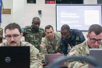 U.S. Army Chief Warrant Officer 2 Kyle Barboza, 176th Cyber Protection Team, assists international service members from Zambia, teaching cyber detection and incident response at the Professional Education Center in Little Rock, Arkansas, on July 15, 2026.