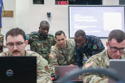 U.S. Army Chief Warrant Officer 2 Kyle Barboza, 176th Cyber Protection Team, assists international service members from Zambia, teaching cyber detection and incident response at the Professional Education Center in Little Rock, Arkansas, on July 15, 2026.