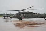 A Texas Army National Guard UH-60 Black Hawk helicopter moves across the flight line past another UH-60 Black Hawk at the San Antonio Army Aviation Support Facility in San Antonio, July 16, 2026. The aircraft deployed to the Kerrville and Castroville areas to support search and rescue operations, aerial reconnaissance, river assessments and requests for assistance at residences following severe weather. (U.S. Army National Guard photo by Capt. Michael A. Ortiz)