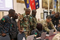 U.S. Army Chief Warrant Officer 2, Kyle Barboza, 176th Cyber Protection Team, assists international service members from Zambia, teaching cyber detection and incident response at the Professional Education Center in Little Rock, Arkansas on July 15, 2026.