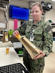 Pharmacist in military uniform work in pharmacy.