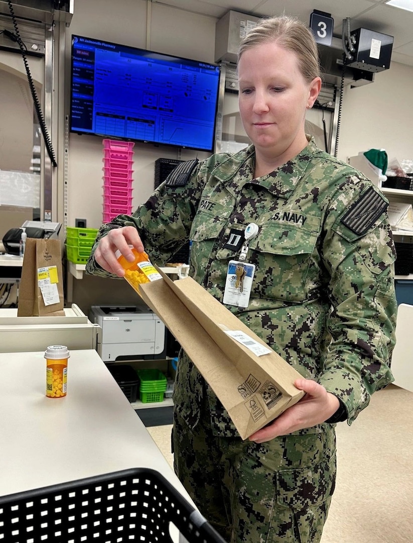 Pharmacist in military uniform work in pharmacy.