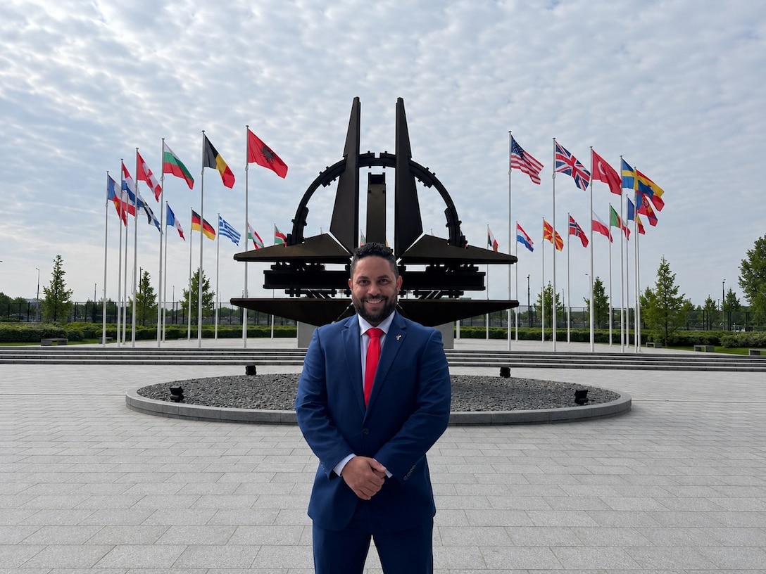 Giovanni Morales, business support branch chief for the Business Support Branch, Defense Logistics Agency Troop Support, and a Department of War Executive Leadership Development Program participant, stands outside the NATO Headquarters in Brussels, Belgium. Morales visited NATO as part of a rigorous 10-month ELDP travel schedule designed to prepare future defense executives for leadership roles. The global training allowed Morales to engage with international ambassadors and understand how logistics support agreements impact frontline military operations.