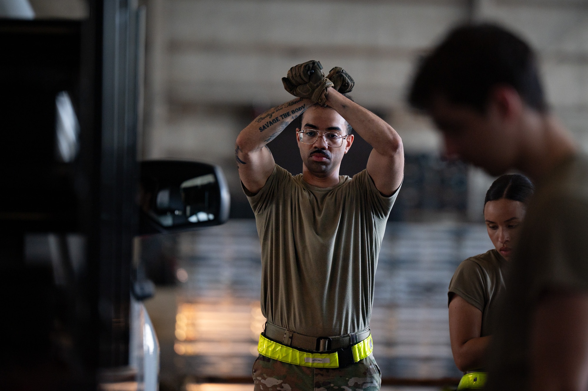 U.S. Air Force Staff Sgt. Rawn Prowell, 305th Aerial Port Squadron passenger services supervisor, signals to stop a vehicle during a Port Dawg Rodeo at Joint Base McGuire-Dix-Lakehurst, N.J., July 10, 2026. Airmen calculated the center of balance on three vehicles during the rodeo and were evaluated on their ability to quickly complete the task with the fewest mistakes possible. (U.S. Air Force photo by Airman 1st Class Haeleigh Bayle)