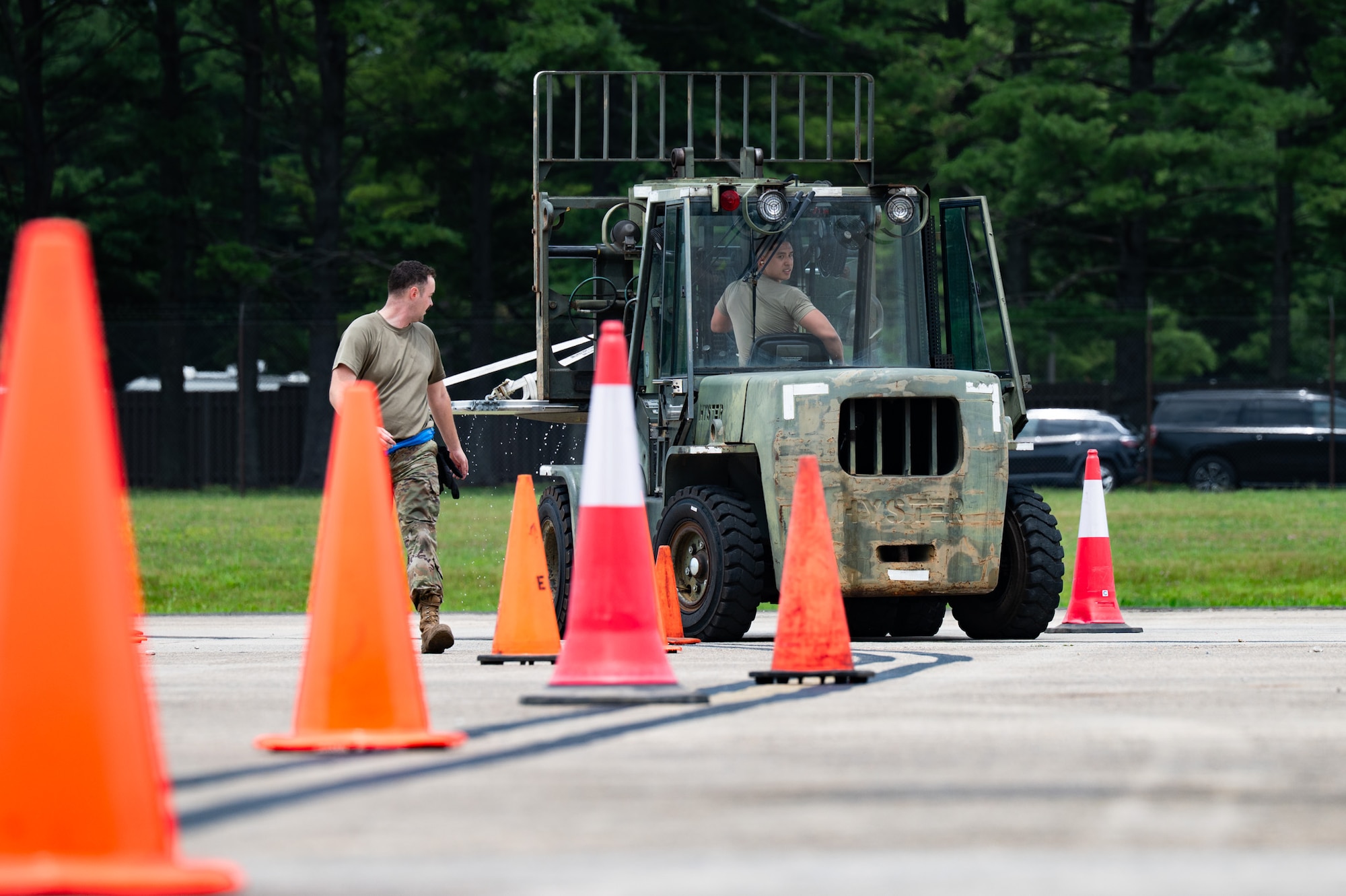 U.S. Air Force Senior Airman Dan Marco Casil, 305th Aerial Port Squadron air transportation journeyman, operates a 10K standard forklift during a Port Dawg Rodeo at Joint Base McGuire-Dix-Lakehurst, N.J., July 10, 2026. During this challenge, Airmen had to complete an obstacle course with a water cooler tied down to the forklift, spilling as little water as possible. (U.S. Air Force photo by Airman 1st Class Haeleigh Bayle)