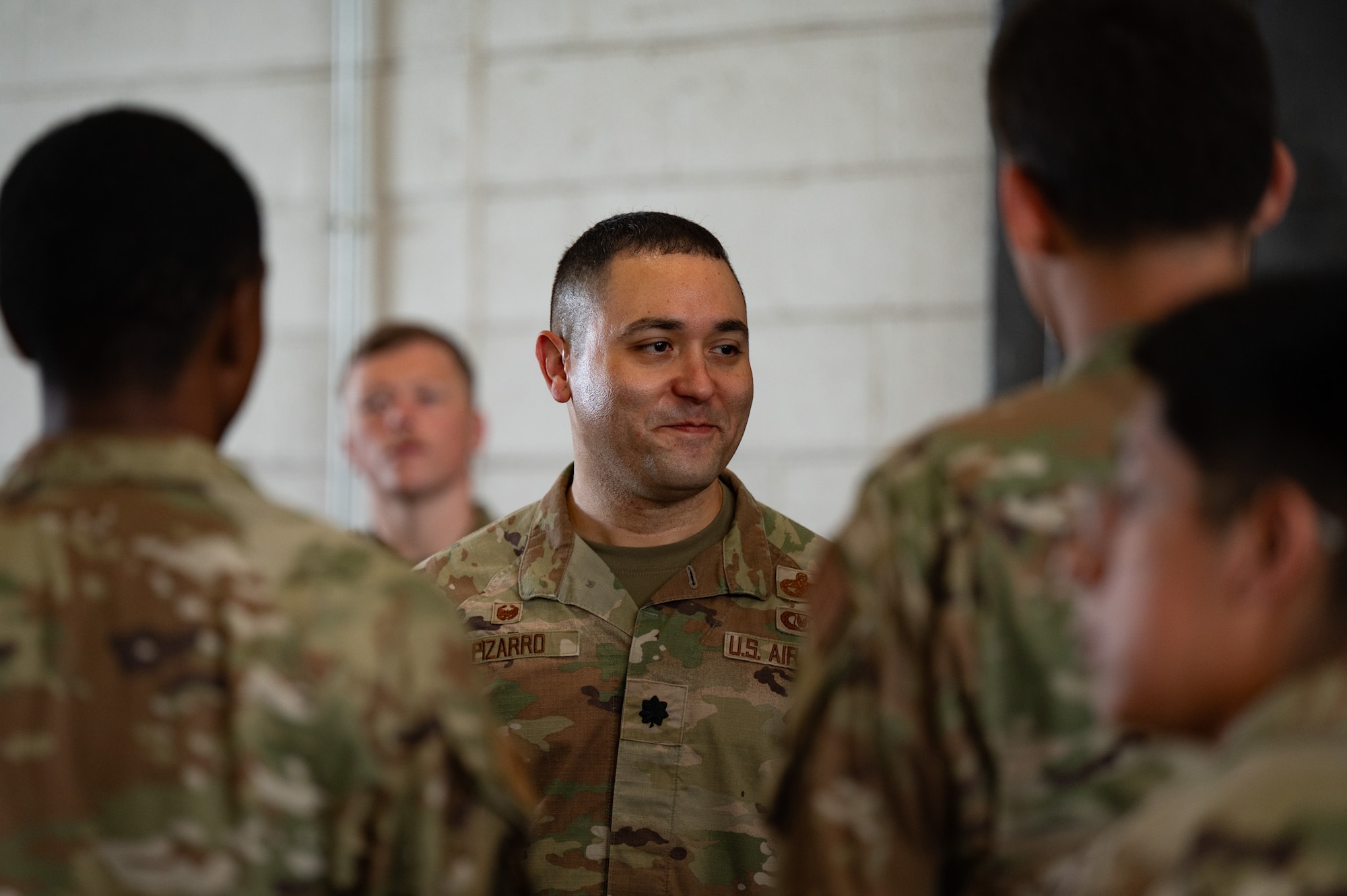 U.S. Air Force Lt. Col. Juan Pizarro, 305th Aerial Port Squadron commander, interacts with Airmen before the start of the 305th APS Port Dawg Rodeo at Joint Base McGuire-Dix-Lakehurst, N.J., July 10, 2026. The rodeo tested Airmen’s knowledge on different aspects of their career field through a timed and evaluated competition comprised of four four-person teams. (U.S. Air Force photo by Airman 1st Class Haeleigh Bayle)