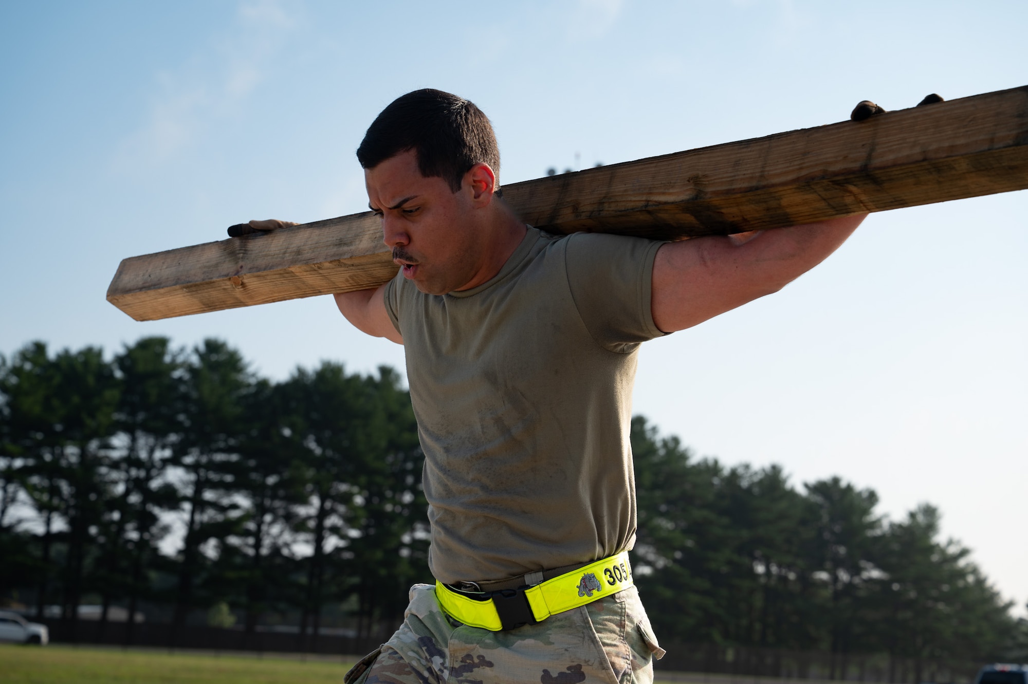 U.S. Air Force Staff Sgt. Suriel Martinez Montalvo, 305th Aerial Port Squadron Traffic Management Office inbound receiving noncommissioned officer in charge, lunges with a dunnage during a Port Dawg Rodeo at Joint Base McGuire-Dix-Lakehurst, N.J., July 10, 2026. Airmen began the rodeo by competing in a fitness challenge where they performed burpees, pushups, squats, pallet carries, dunnage transfers and other physically demanding tasks to test their mental resilience and physical endurance. (U.S. Air Force photo by Airman 1st Class Haeleigh Bayle)