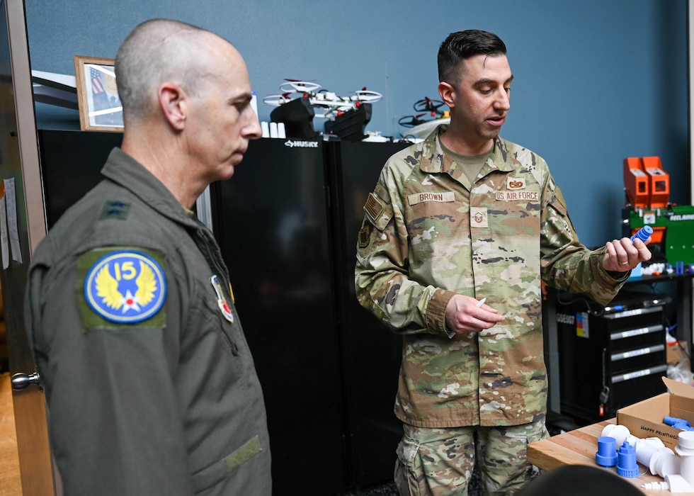 U.S. Air Force Maj. Gen. Steven Behmer, 15th Air Force commander, speaks with Master Sgt. John Brown, 56th Fighter Wing Commander’s Action Group wing innovation manager, during a base tour at Luke Air Force Base, Arizona, July 20, 2026.