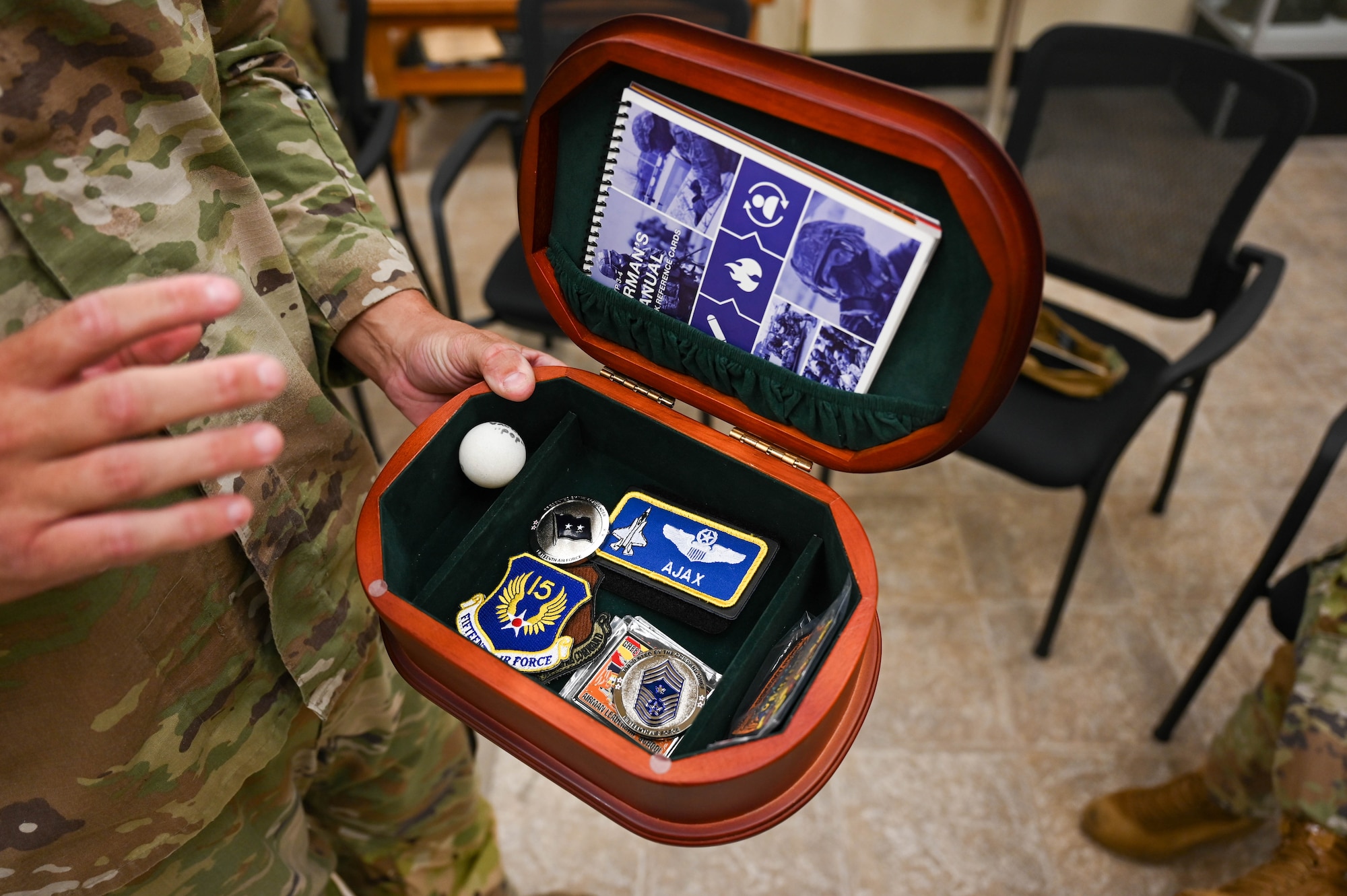 A U.S. Airman holds a time capsule put together by members of the 56th Force Support Squadron Airman Leadership School during a base tour at Luke Air Force Base, Arizona, July 20, 2026.
