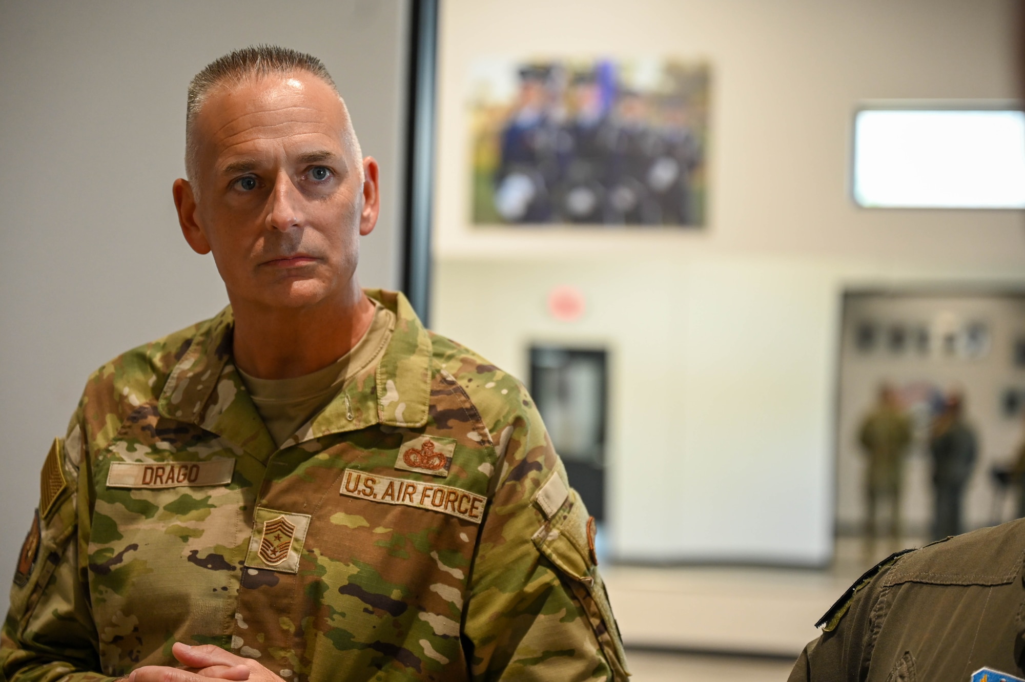 U.S. Air Force Chief Master Sgt. Nikki Drago, 15th Air Force command chief, listens to a briefer during a base tour at Luke Air Force Base, Arizona, July 20, 2026.