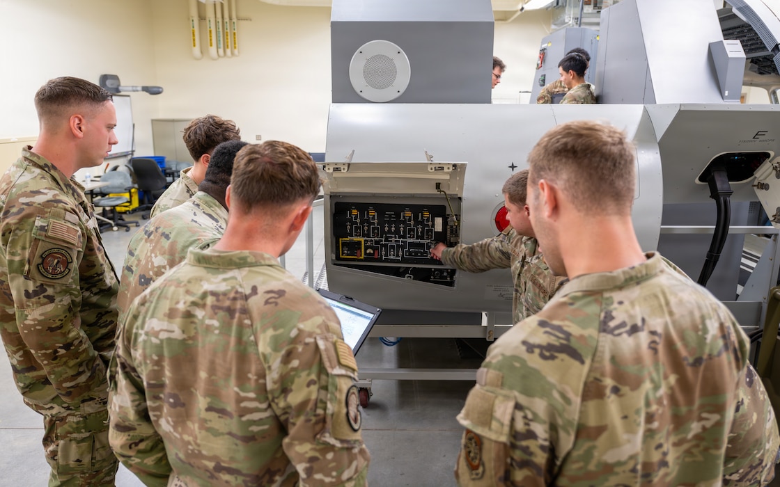 Airmen monitor control panel.