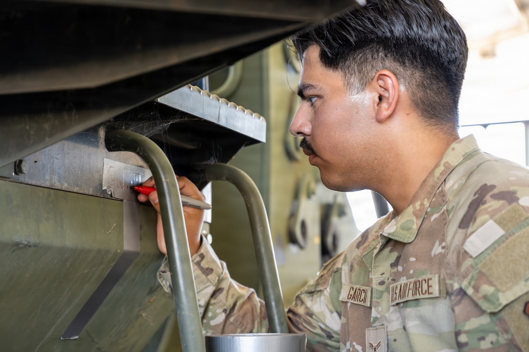 Airman writes note on forklift.