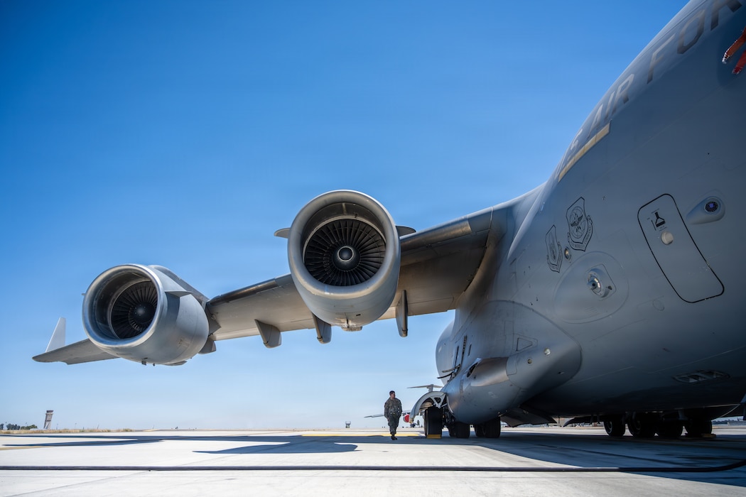 Airman inspects airplane.