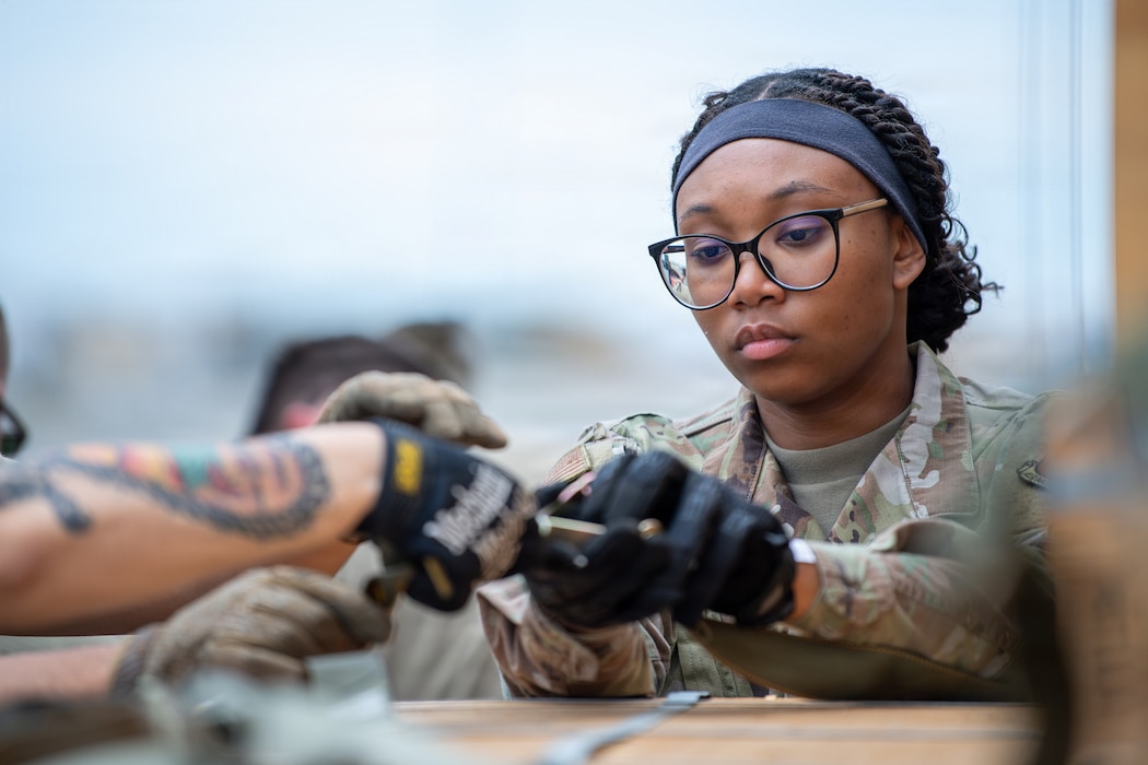 Airman tightens straps on cargo.