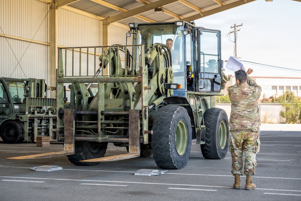 Airman directs forklift.