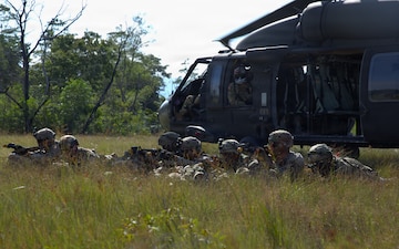 U.S. Army infantrymen assigned to Company C, “Kulepbla,” and Company D, “Dulaslas,” 1st Battalion, 294th Infantry Regiment, Guam Army National Guard, pull security around the landing zone of a UH-60 Black Hawk helicopter after inserting into their area of operations during air assault training as part of Exercise Keris Strike 26 conducted near Kota Belud inSabah, Malaysia, July 17, 2026.