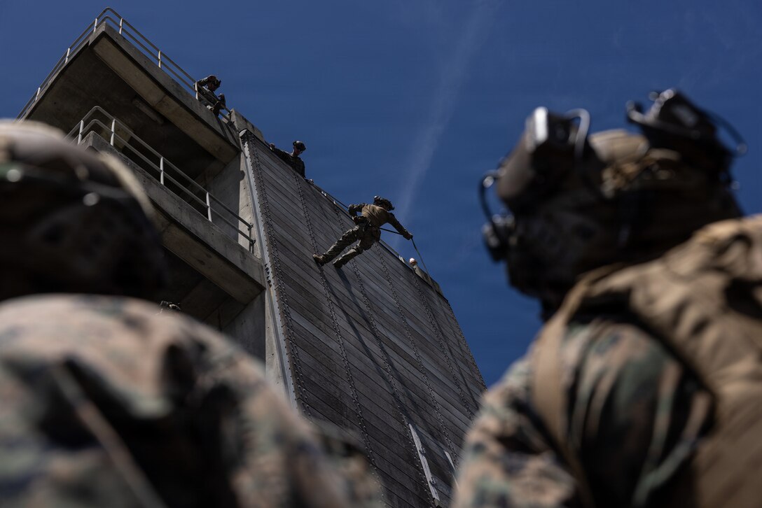U.S. Marine Corps Cpl. Kyle Young, a rifleman with 12th Littoral Combat Team, 12th Marine Littoral Regiment, 3rd Marine Division, rappels down a tower during a fast-rope and rappel qualification at Camp Hansen, Japan, May 7, 2026.