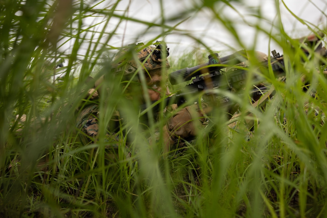 U.S. Marine Corps Pfc. Logan Gray, a machine gunner with 12th Littoral Combat Team, 12th Marine Littoral Regiment, 3rd Marine Division, sights in his scope during force on force training during Resolute Dragon 26 at Japan Self-Defense Force Hijudai Maneuver Area, Oita Prefecture, Japan, June 20, 2026. Resolute Dragon is an annual bilateral exercise in Japan that strengthens the command, control, and multi-domain maneuver capabilities of U.S. Marines in III Marine Expeditionary Forces and Japan Self-Defense Forces personnel, with a focus on controlling and defending key maritime terrain. Gray is a native of Georgia. (U.S. Marine Corps photo by Lance Cpl. Camila Garibay)