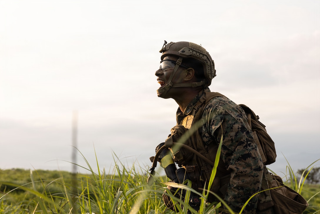 U.S. Marine Corps Sgt. Noah Martin, a rifleman with 12th Littoral Combat Team, 12th Marine Littoral Regiment, 3rd Marine Division, communicates with his squad during a dry-run squad-sized attack at Combined Arms Training Center Camp Fuji, Japan, July 10, 2026. Through rigorous squad-level exercises, small-unit leaders and rifle squads refine their tactical proficiency, combat readiness, and increase unit cohesion. Martin is a native of Kansas. (U.S. Marine Corps photo by Lance Cpl. Camila Garibay)