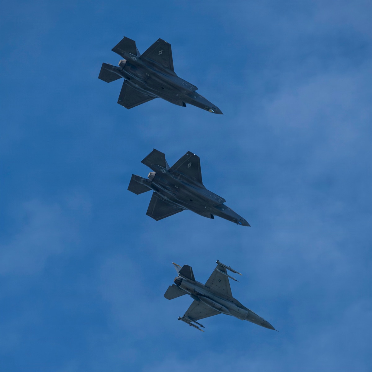 U.S. Air Force Col. Paul Davidson, 35th Fighter Wing commander, flies an F-16 Fighting Falcon alongside two F-35 Lighning IIs during his final flight at Misawa Air Base, Japan, June 7, 2026. The final flight celebrated the completion of Col. Davidson’s command, reflecting the enduring tradition of recognizing leaders whose service shaped the wing’s mission and culture. (U.S. Air Force photo by Senior Airman Patrick Boyle)