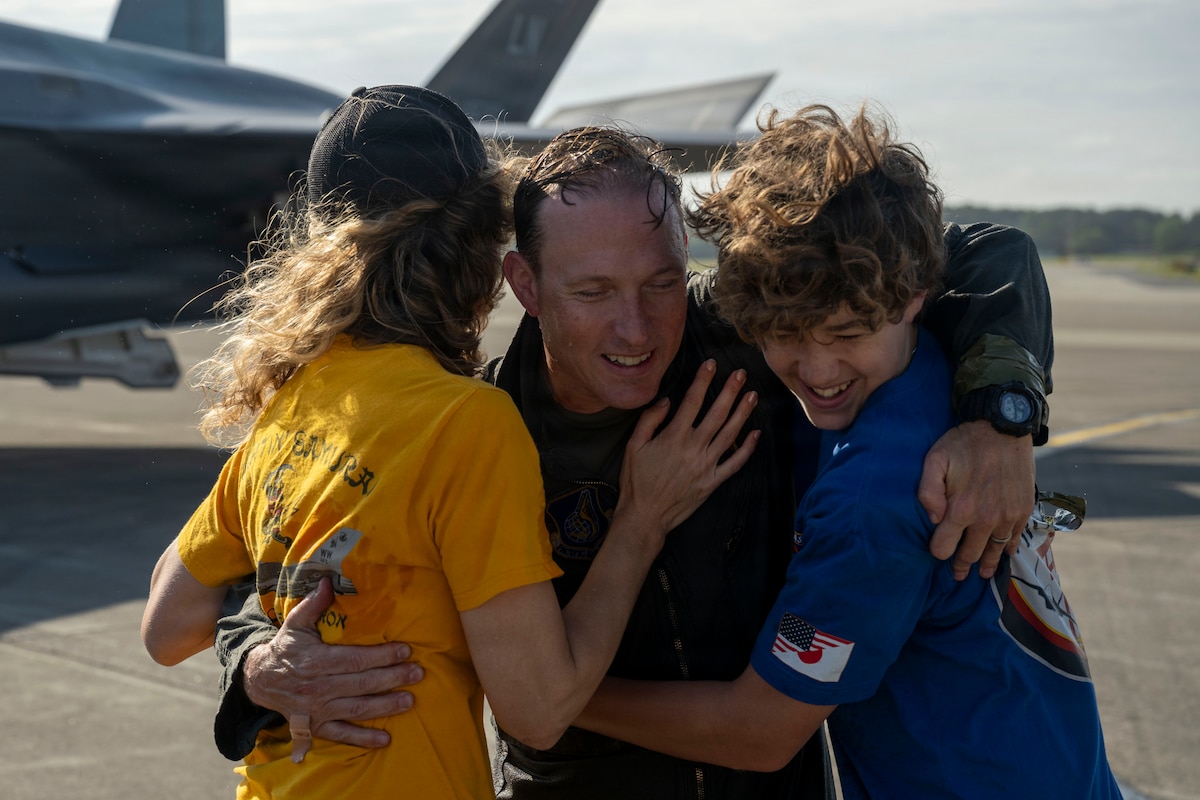 U.S. Air Force Col. Paul Davidson, 35th Fighter Wing commander, hugs his family after his final flight at Misawa Air Base, Japan, June 7, 2026. The fini flight recognized Col. Davidson’s final flight as commander, celebrating the conclusion of his flying chapter with the 35th Fighter Wing before beginning his next assignment. (U.S. Air Force photo by Senior Airman Patrick Boyle)