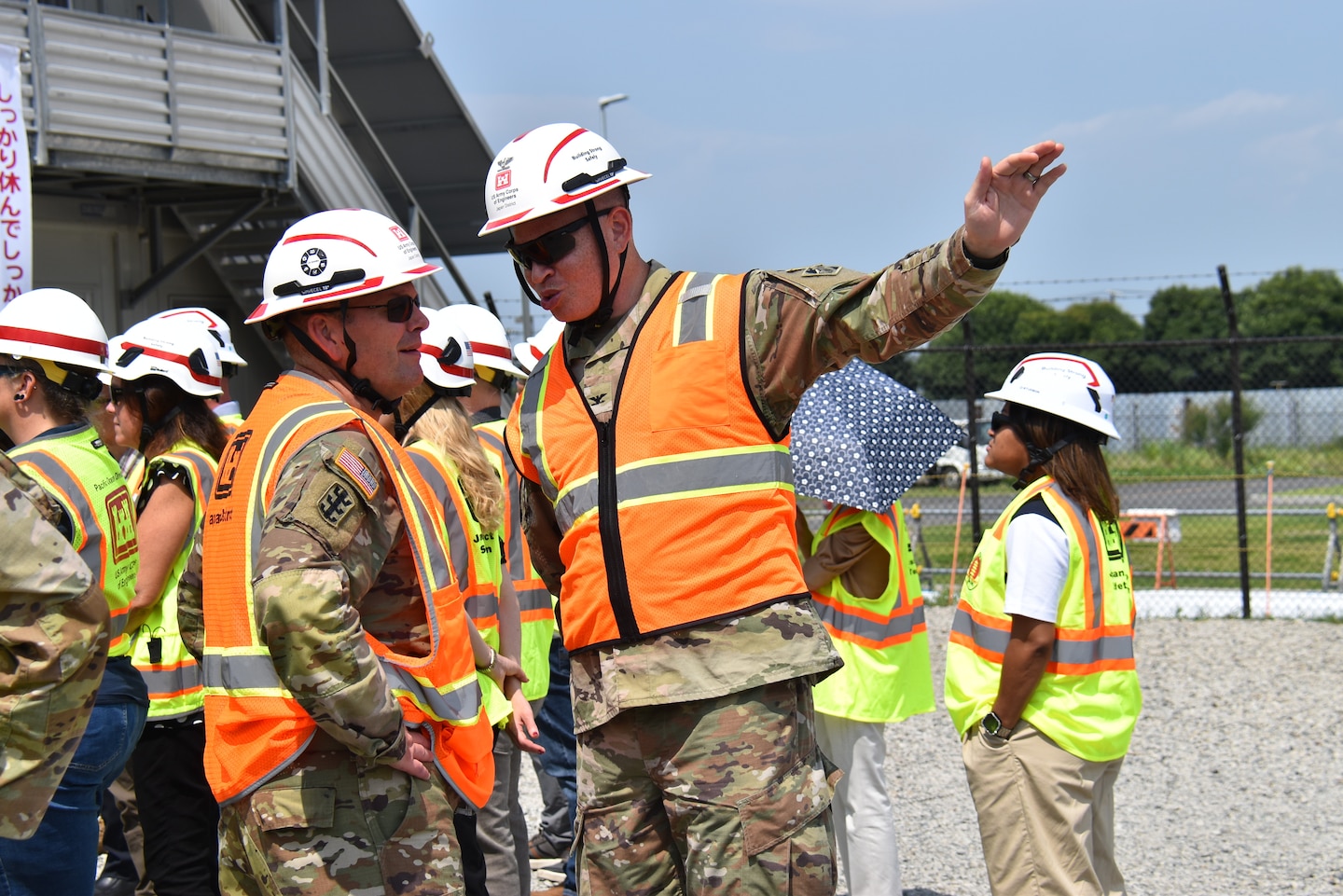 Col. Patrick Biggs, commander, U.S. Army Corps of Engineers – Japan District, speaks with Col. Christopher Crary, deputy commander, USACE Pacific Ocean Division, during construction site visits on Yokota Air Base, Japan, on July 21, 2026