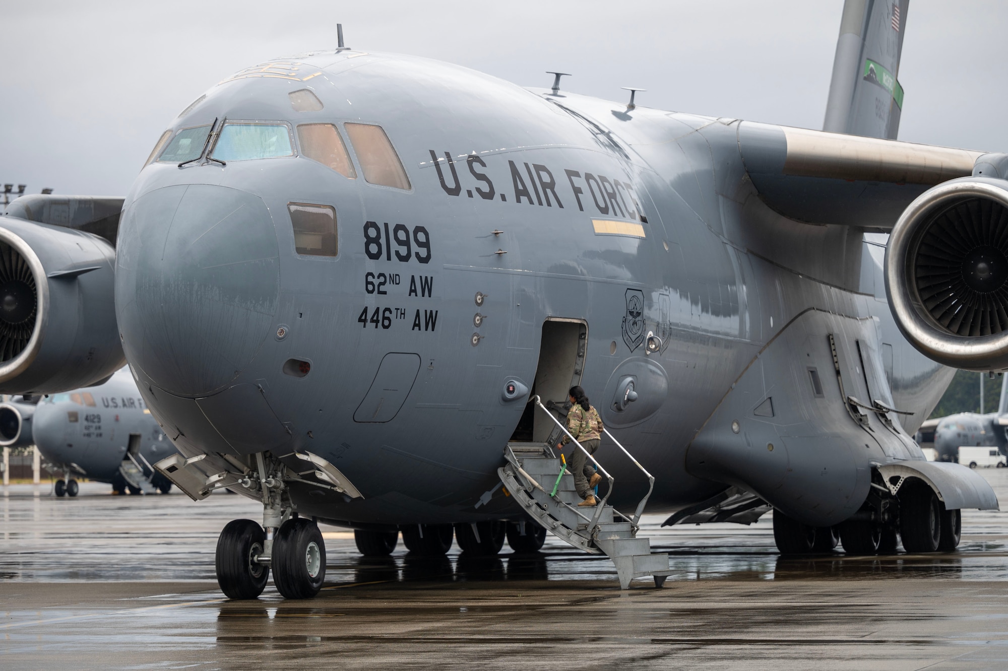 a military aircraft parked on a flightline taken from the front and slightly to the side