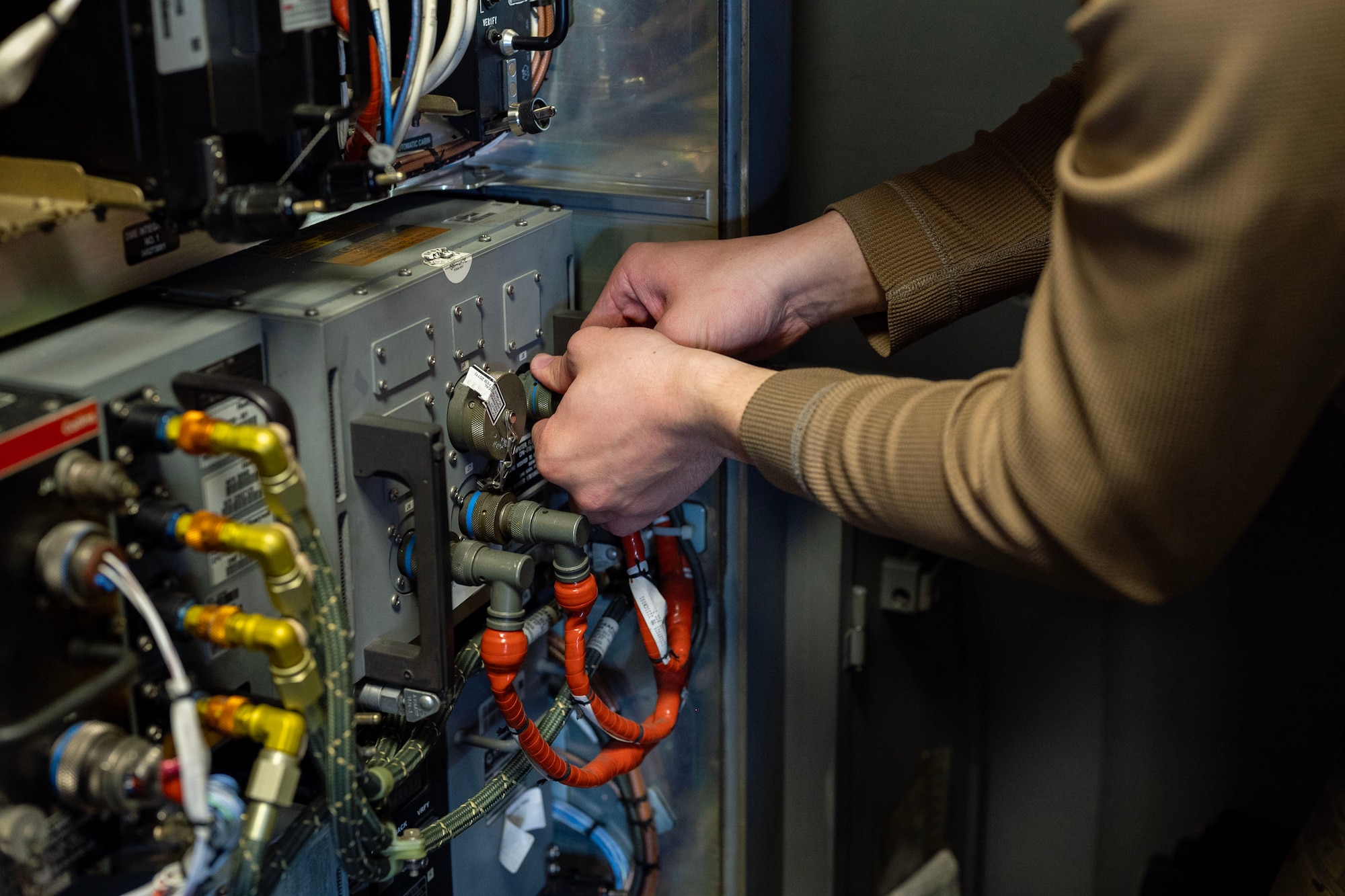 two hands connecting wires and other electrical components