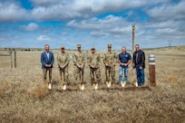 Image of Personnel and leadership posing with shovels in a field.