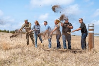Image of Contractors shoveling dirt into the air.