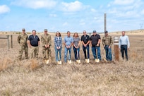 Image of Contractors pose with shovels in a field.