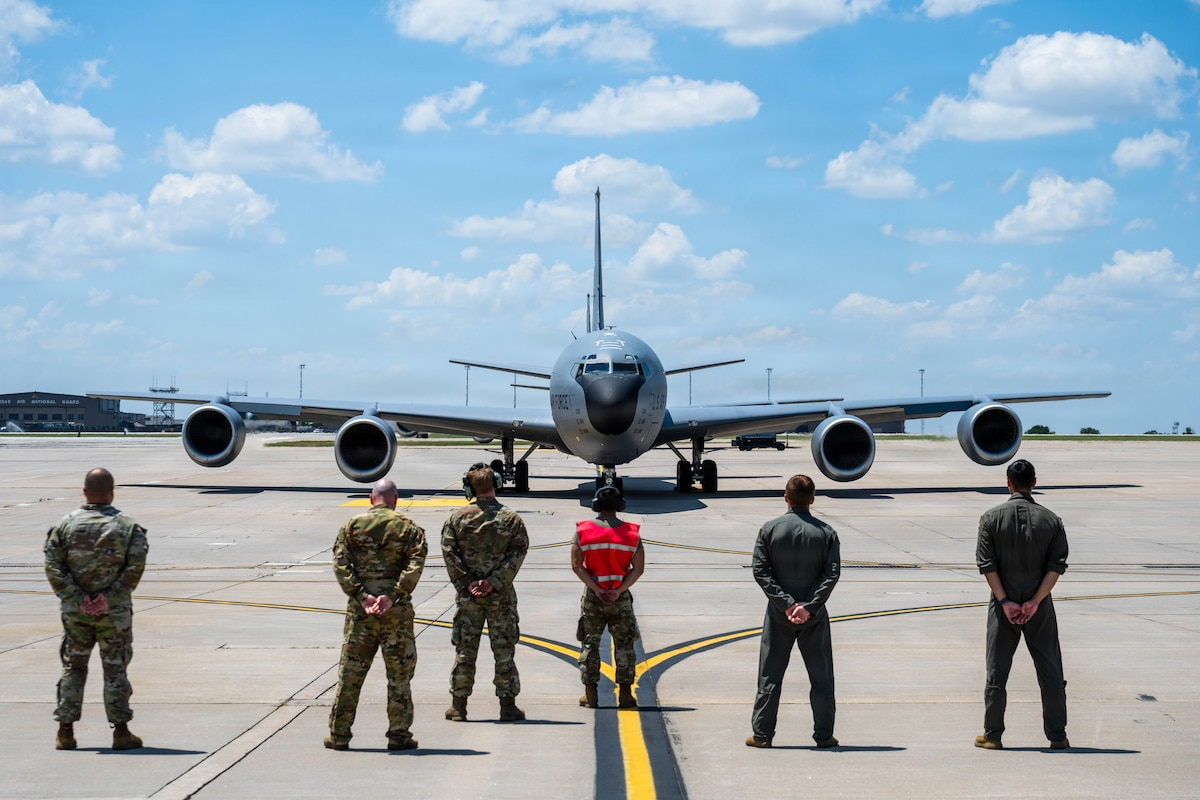 Members of the 350th Air Refueling Squadron stand behind a crew chief to honor A KC-135 Stratotanker’s final flight out of McConnell Air Force Base, Kansas, July 14, 2026. The jet was flown to MacDill Air Force Base, Florida, by a crew from the 99th Air Refueling Squadron out of Birmingham Alabama. (U.S. Air Force photo by Airman 1st Class Patrick O’Neill)