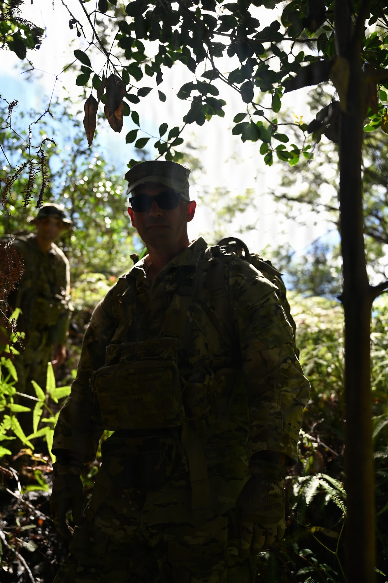 Chief Master Sgt. Christopher Distel poses for a photo while hiking through steep terrain during annual training at Schofield Barracks, Hawaii, July 13, 2026. The training challenges Airmen to strengthen tactical proficiency, teamwork and expeditionary readiness while operating in unfamiliar terrain and austere conditions. (U.S. Air National Guard photo by Tech. Sgt. Tiffany Scofield)