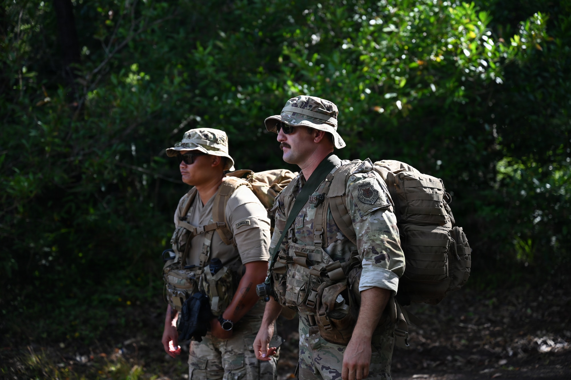1st Lt. Kyle Mackerig, a guest jungle instructor from the 820th Base Defense Group at Moody Air Force Base, Georgia, stands alongside Master Sgt. Bradley Akers while briefing Security Forces Airmen before the start of training at Schofield Barracks, Hawaii, July 13, 2026. The training challenges Airmen to strengthen tactical proficiency, teamwork and expeditionary readiness while operating in unfamiliar terrain and austere conditions. (U.S. Air National Guard photo by Tech. Sgt. Tiffany Scofield)