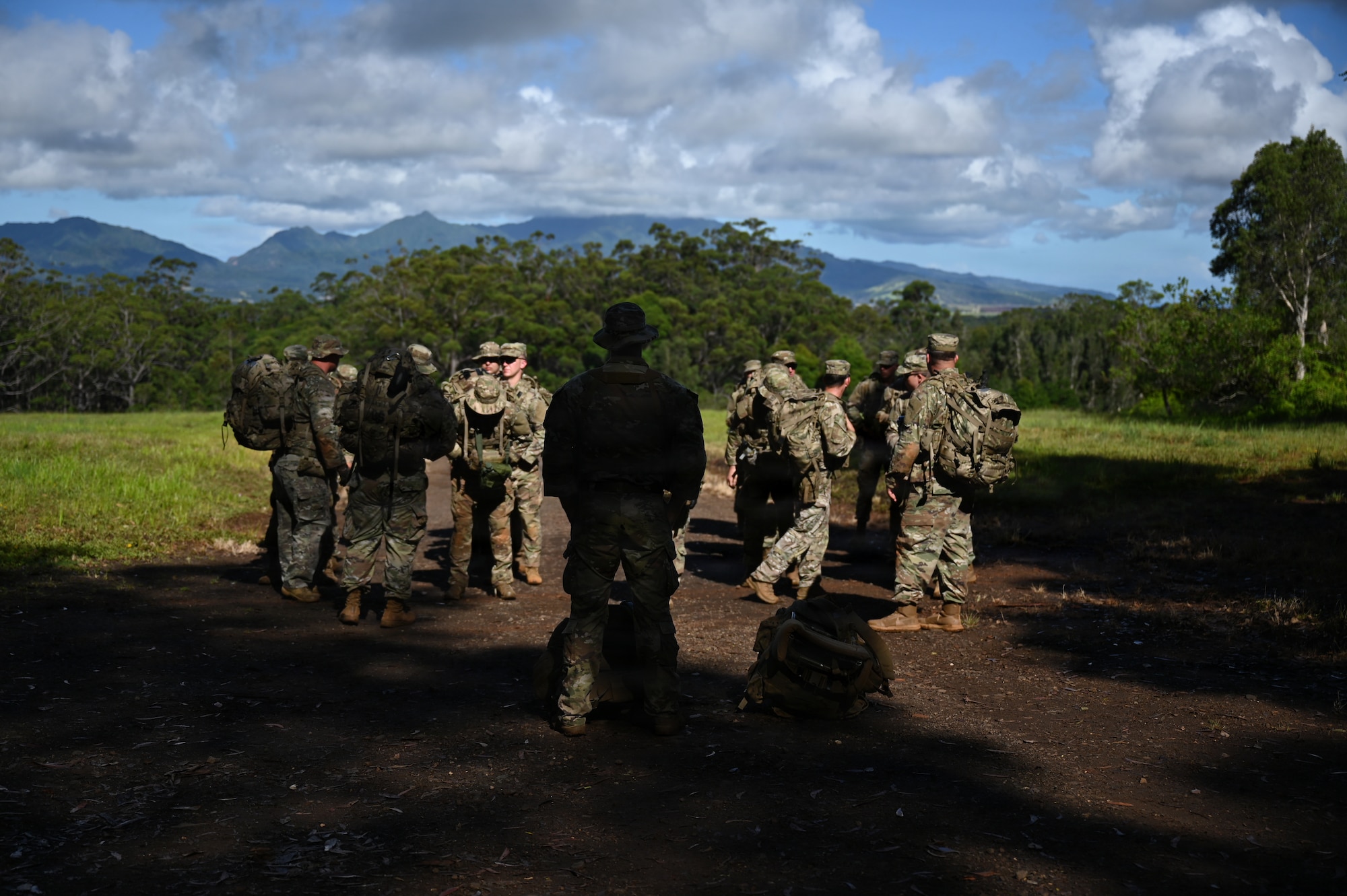 Master Sgt. Bradley Akers briefs Security Forces Airmen before the start of training at Schofield Barracks, Hawaii, July 13, 2026. The training challenges Airmen to strengthen tactical proficiency, teamwork and expeditionary readiness while operating in unfamiliar terrain and austere conditions. (U.S. Air National Guard photo by Tech. Sgt. Tiffany Scofield)