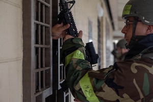 U.S. Air Force Tech. Sgt. Arthur Heinrich, 8th Communications Squadron cyber operations section chief, receives an M4 carbine as part of the general arming process during exercise Beverly Sentinel 26-4 at Kunsan Air Base, Republic of Korea, July 21, 2026.