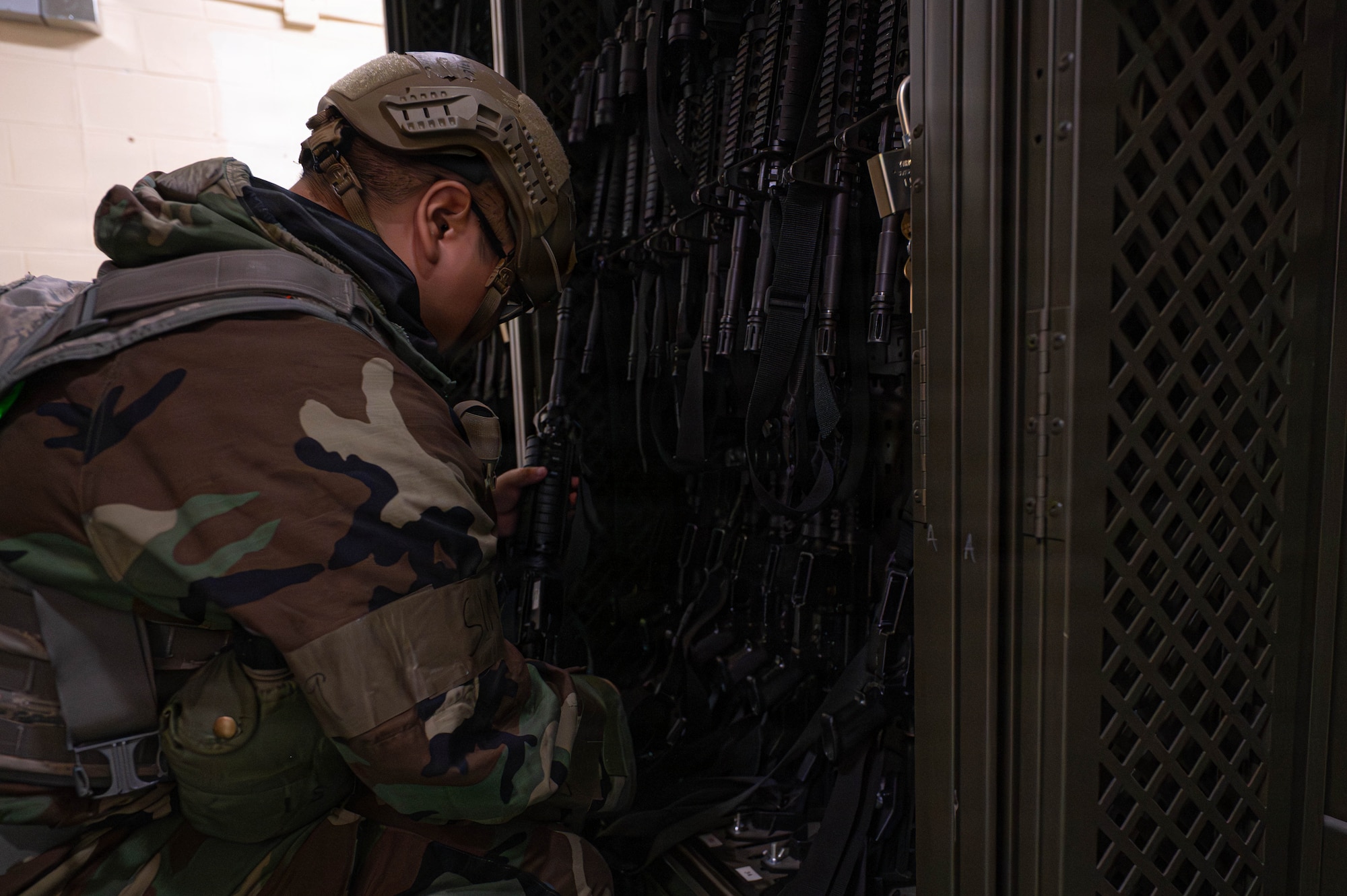 U.S. Air Force Airman 1st Class Darren Poblete, 8th Logistics Readiness Squadron inventory journeyman, grabs M4 carbines to be issued during exercise Beverly Sentinel 26-4 at Kunsan Air Base, Republic of Korea, July 21, 2026. The Wolf Pack holds several Ability to Survive and Operate exercises throughout the year, this iteration emphasized base defense and featured rapid arming and quick weapons training. (U.S. Air Force photo by Staff Sgt. Cedrique Oldaker)
