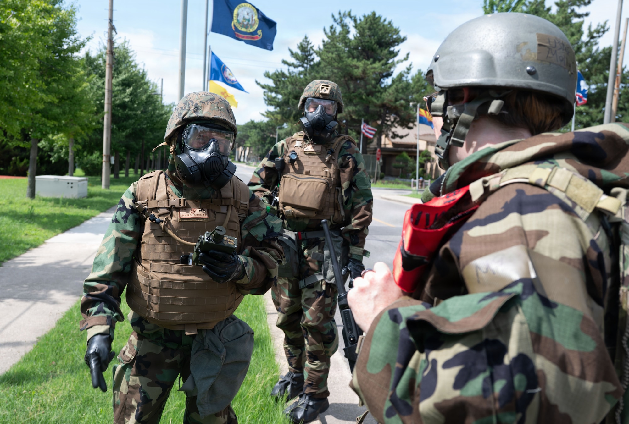 U.S. Marine Lance Cpl. Everett Bonilla, left, and Garrett Bruening, center, Chemical, Biological, Radiological and Nuclear responders assigned to Marine Wing Support Squadron 171, Marine Air Station, Iwakuni, Japan, receive CBRN detection guidance from U.S. Air Force Master Sgt. Molly Clune, right, 8th Civil Engineer Squadron Readiness and Emergency Management superintendent, during exercise Beverly Sentinel 26-4 at Kunsan Air Base, Republic of Korea, July 22, 2026. By exchanging tactics, techniques, and procedures, Airmen and Marines forged a dynamic and lethal operational playbook, honing capabilities to overcome complex challenges as a single, cohesive unit.