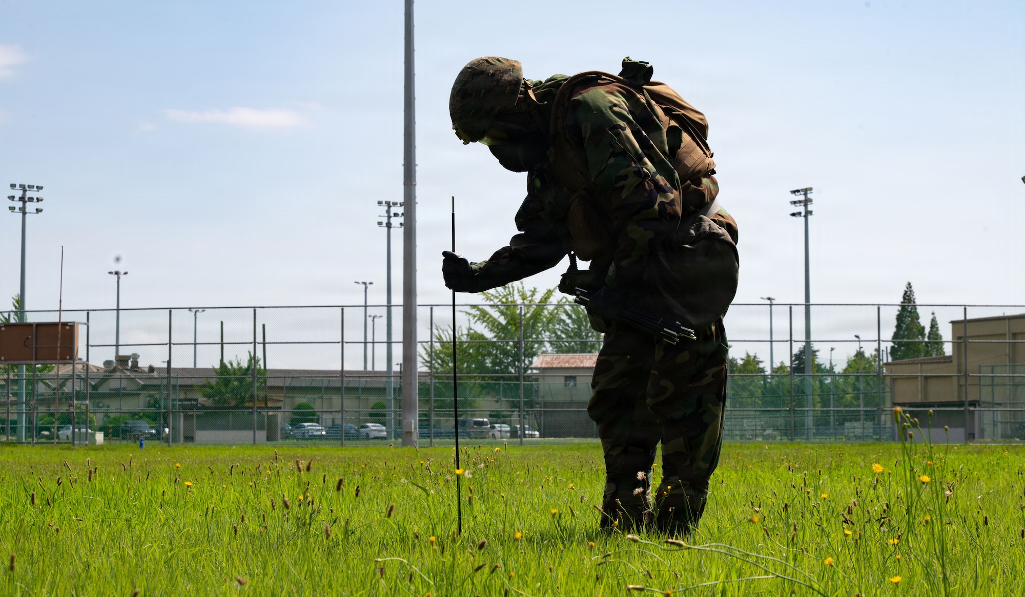 U.S. Marine Lance Cpl. Garrett Bruening, a Chemical, Biological, Radiological and Nuclear responder assigned to Marine Wing Support Squadron 171, Marine Air Station, Iwakuni, Japan, plants a cordon marker around a simulated CBRN contaminated area during exercise Beverly Sentinel 26-4 at Kunsan Air Base, Republic of Korea, July 22, 2026. By integrating directly during realistic training scenarios, Airmen and Marines learned more about each other’s operational capabilities, building strong professional relationships essential for success in joint combat environments.