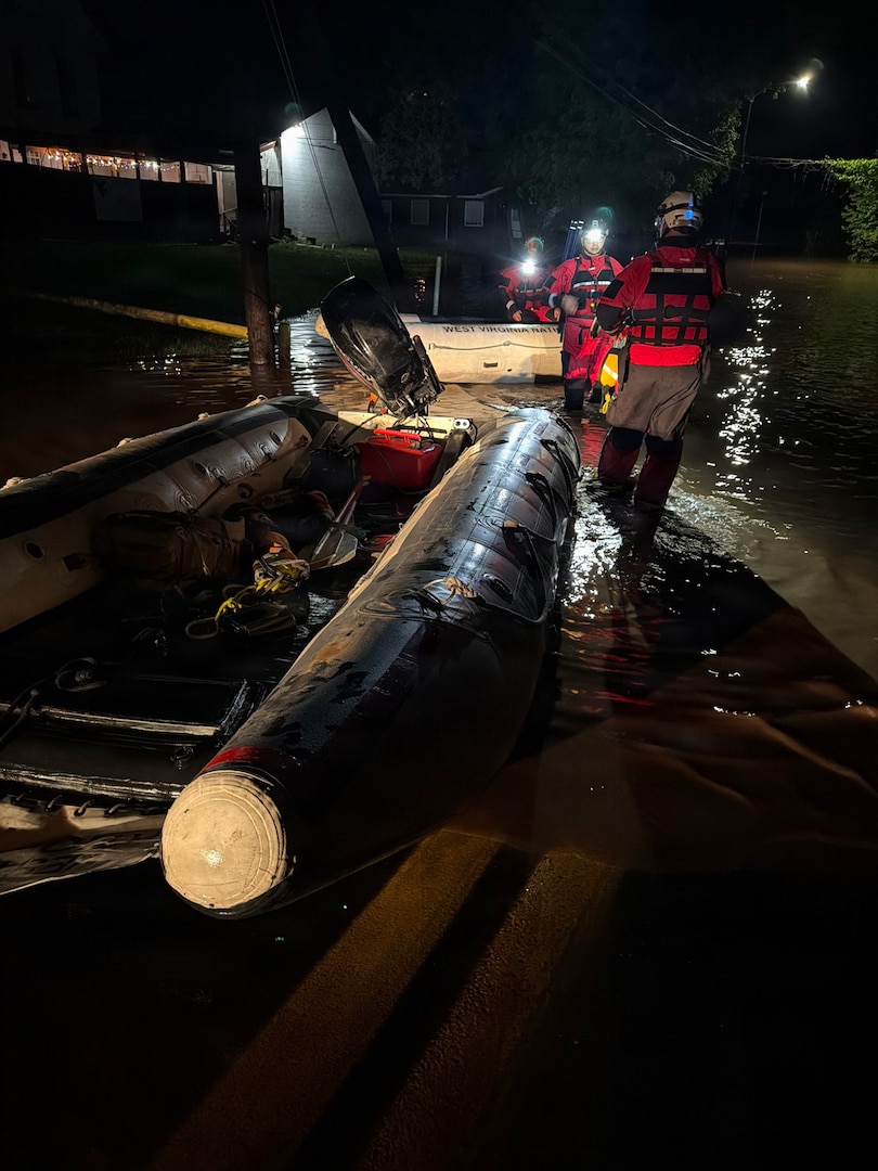 Members of the West Virginia National Guard Swift Water Rescue Team load their boat into floodwaters in north central West Virginia, the night of July 21, 2026.