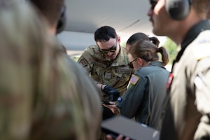 U.S. Air Force Senior Airman Brandon Rivas, 32nd Air Refueling Squadron instructor boom operator, goes over standard operating procedures during specialized fueling operations with Capt. Anna Tuma, 32nd Air Refueling Squadron pilot, at Joint Base McGuire-Dix-Lakehurst, N.J., June 29, 2026.
