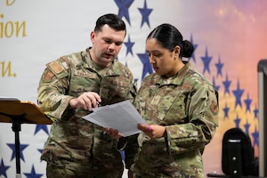 U.S. Air Force Staff Sgt. Cody Ranallo, Air Force Mortuary Affairs Operations noncommissioned officer in charge of readiness and plans, and U.S. Air Force Staff Sgt. Janely Mireya Garcia, AFMAO unit training manager, review checklist items during the in-processing of new deployers, Dover Air Force Base, Delaware, April 1, 2026. (U.S. Air Force photo by Jason Minto)