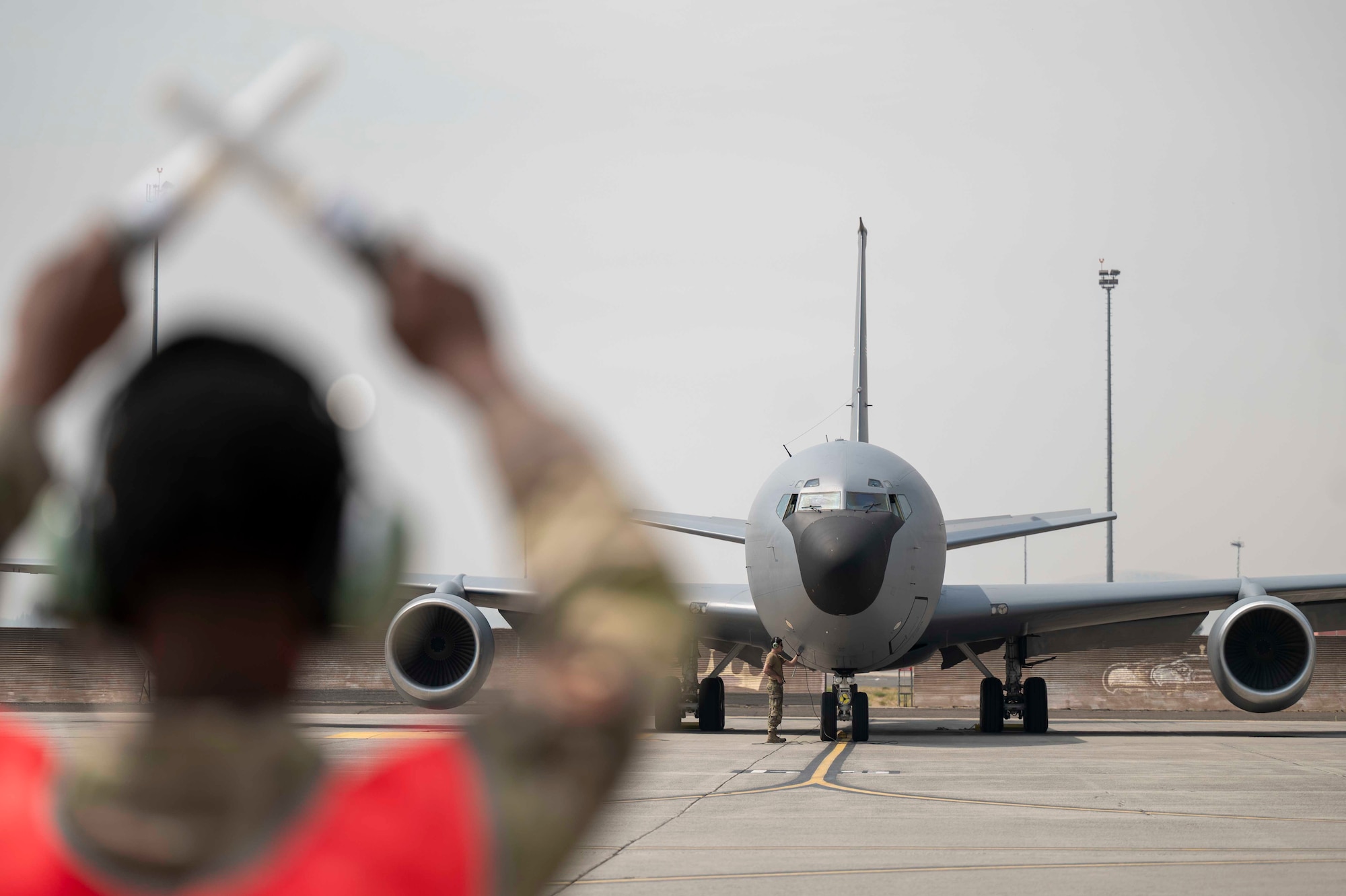 An Airman marshals an aircraft.